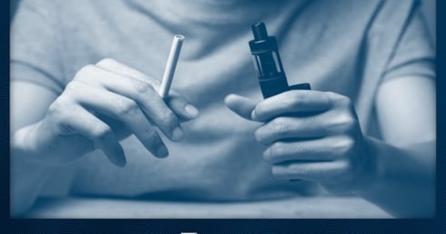 Jemand hält eine Zigarette und eine Vape.